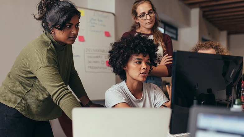 Team looking at computer