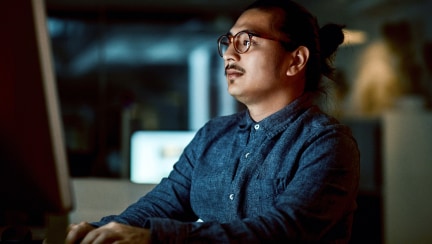 Individual looking at a monitor in an office