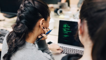 Two collegues looking at a monitor in an office